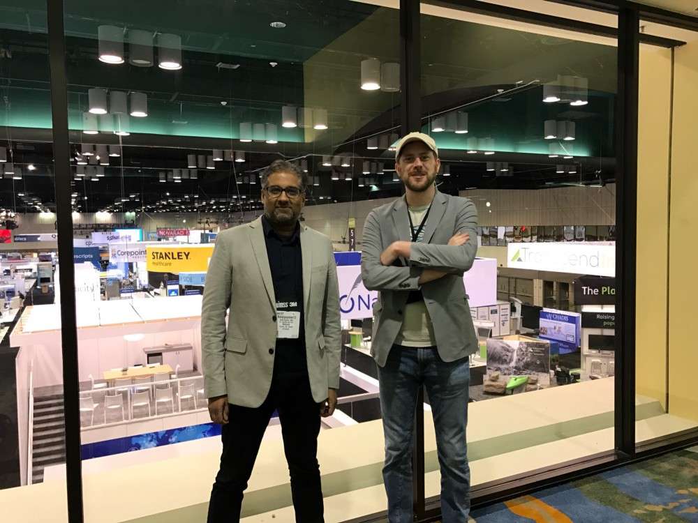 Balaji Gopalan (left) and Simon Woodside (right), the HIMSS17 exhibition floor behind them.